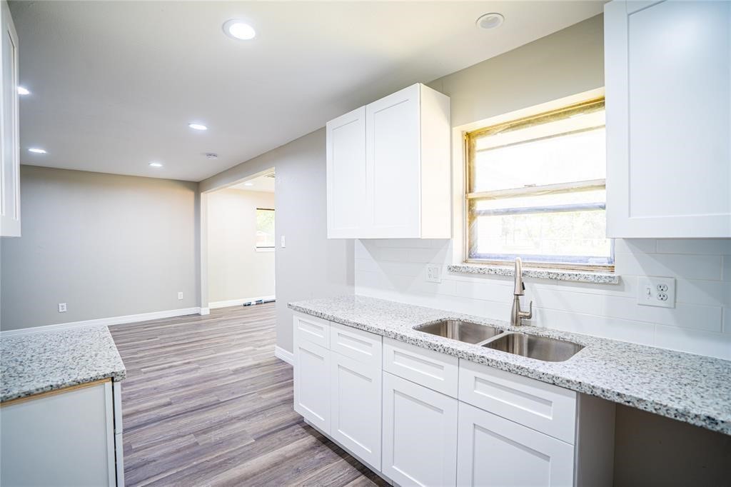 7130 Heath Street Houston, TX 77016 - Photo 15 of 18 a kitchen with a sink cabinets and window