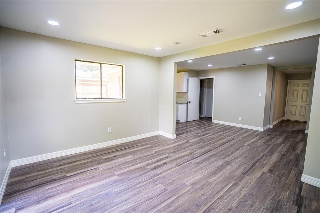 7130 Heath Street Houston, TX 77016 - Photo 16 of 18 an empty room with wooden floor and windows