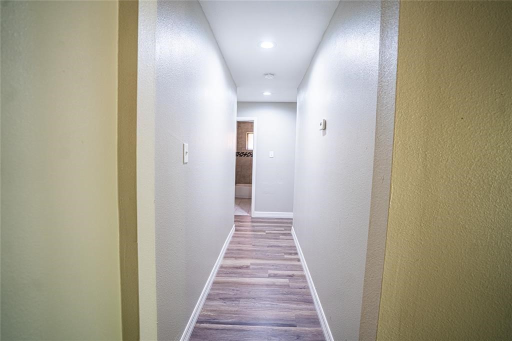 7130 Heath Street Houston, TX 77016 - Photo 17 of 18 a view of a hallway with wooden floor