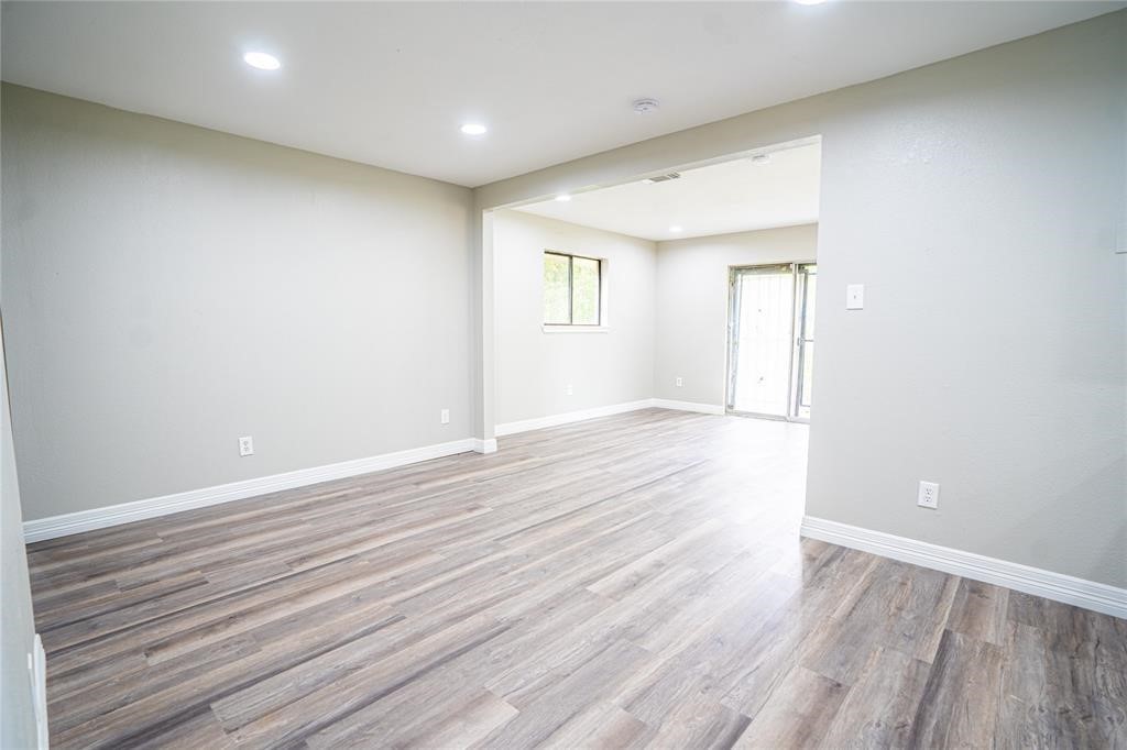 7130 Heath Street Houston, TX 77016 - Photo 2 of 18 an empty room with wooden floor and windows
