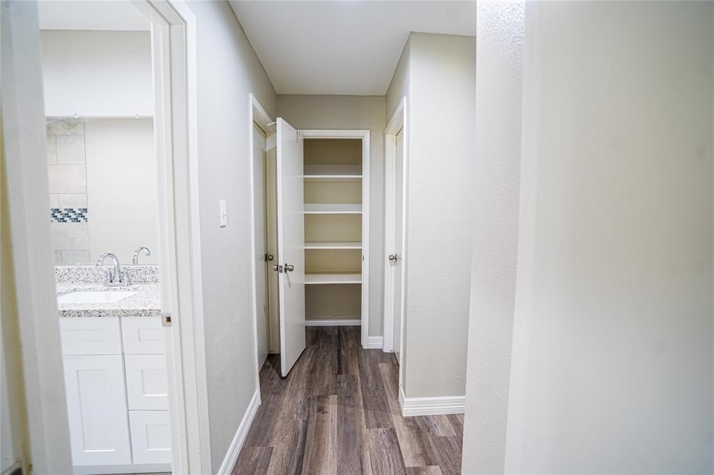 7130 Heath Street Houston, TX 77016 - Photo 6 of 18 a view of a hallway with wooden floor and closet