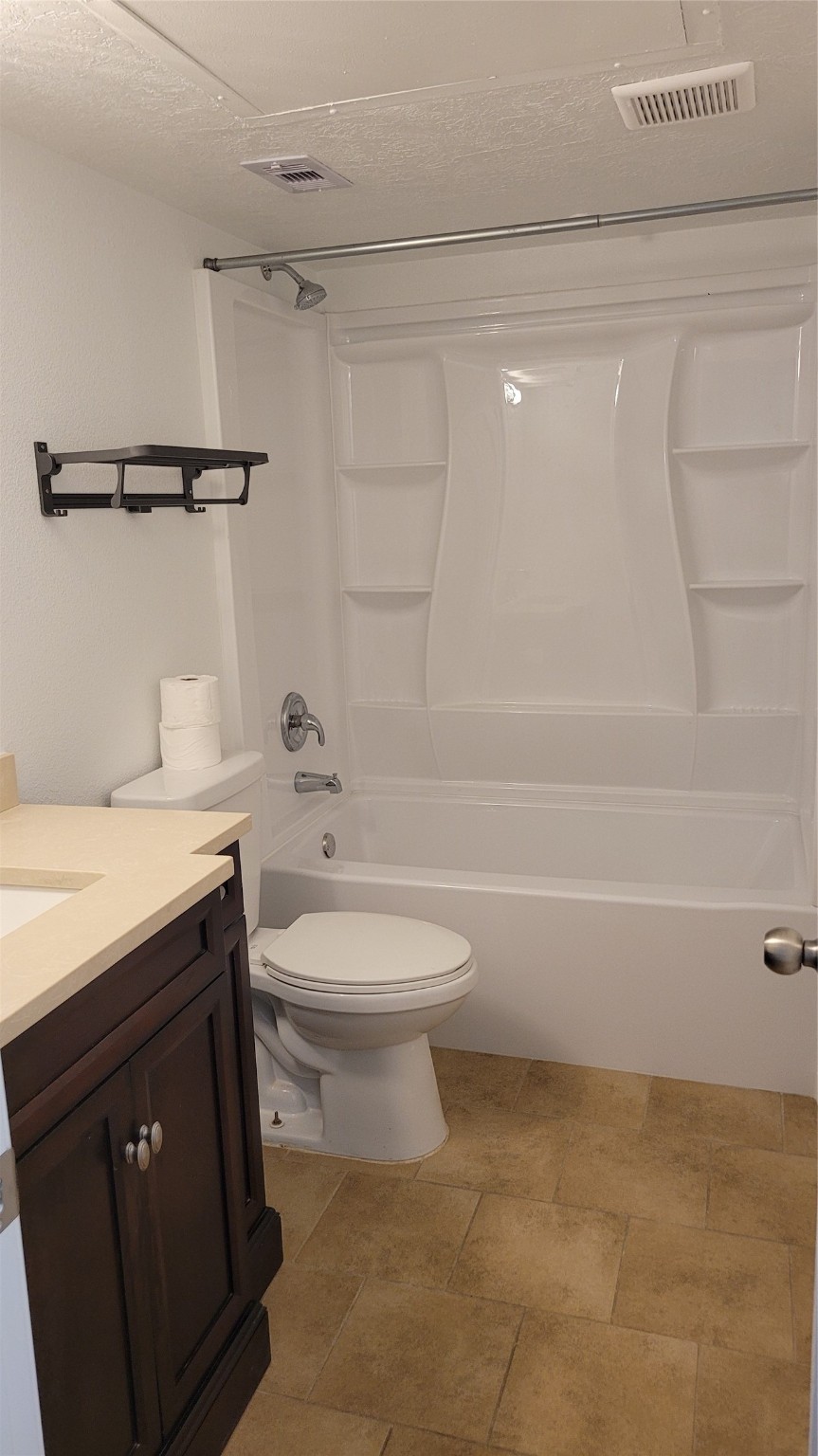 14777 Wunderlich Drive, Unit 112 Houston, TX 77069 - Photo 3 of 23 a bathroom with a granite countertop sink a toilet and shower