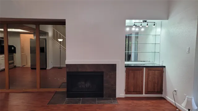 a room with fireplace and a wooden floor