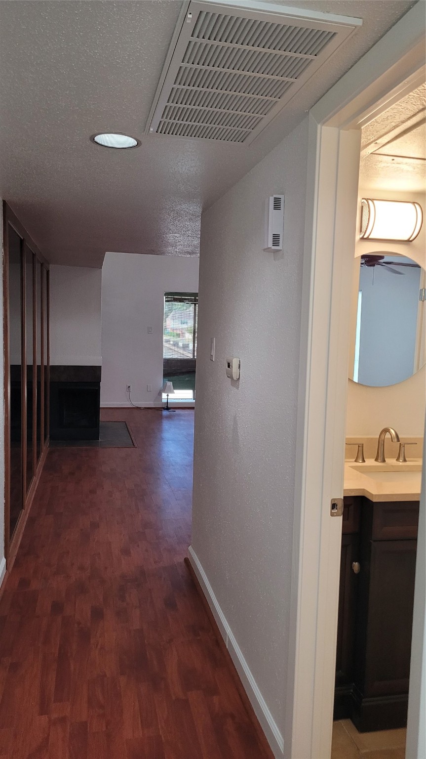14777 Wunderlich Drive, Unit 112 Houston, TX 77069 - Photo 8 of 23 a view of hallway with sink and wooden floor