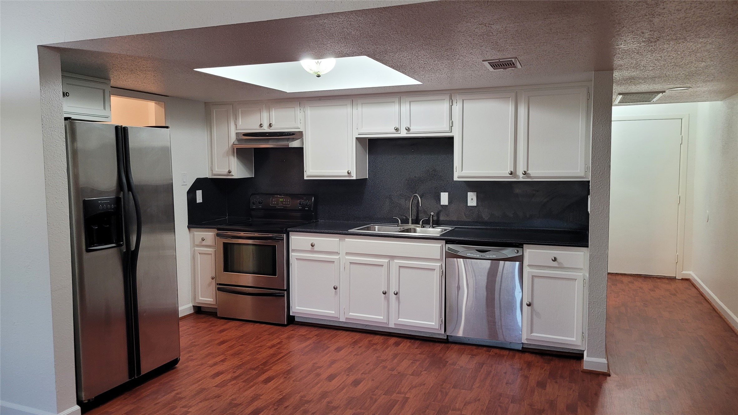 14777 Wunderlich Drive, Unit 112 Houston, TX 77069 - Photo 9 of 23 a kitchen with stainless steel appliances granite countertop a stove a refrigerator and a sink