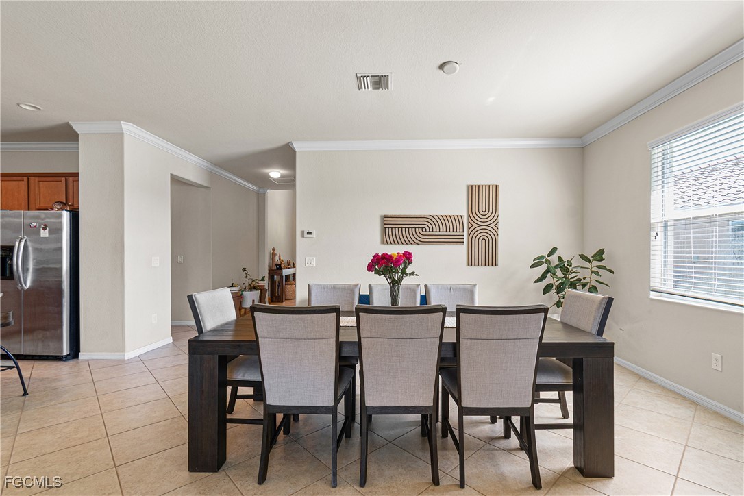 11656 Eros Road Lehigh Acres, FL 33971 - Photo 11 of 49 a view of a dining room with furniture and a window