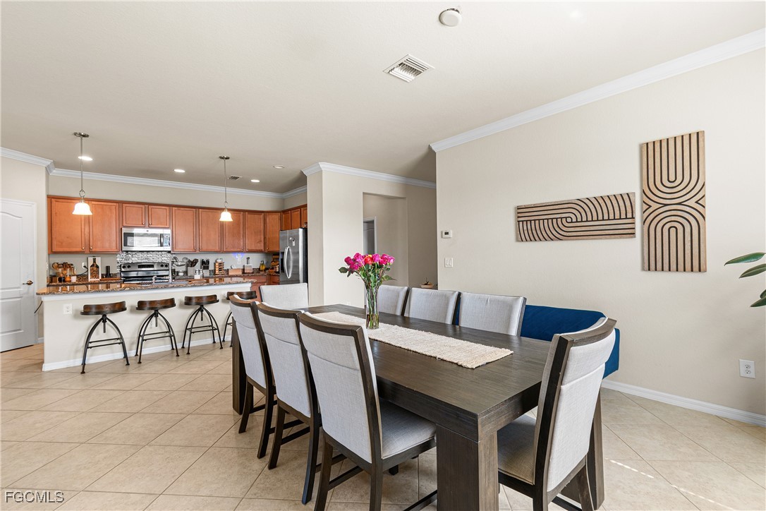 11656 Eros Road Lehigh Acres, FL 33971 - Photo 12 of 49 a view of a dining room with furniture