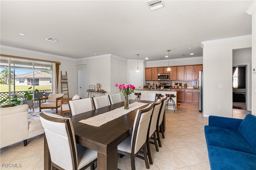 11656 Eros Road Lehigh Acres, FL 33971 - Photo 13 of 49 a view of a dining room with furniture