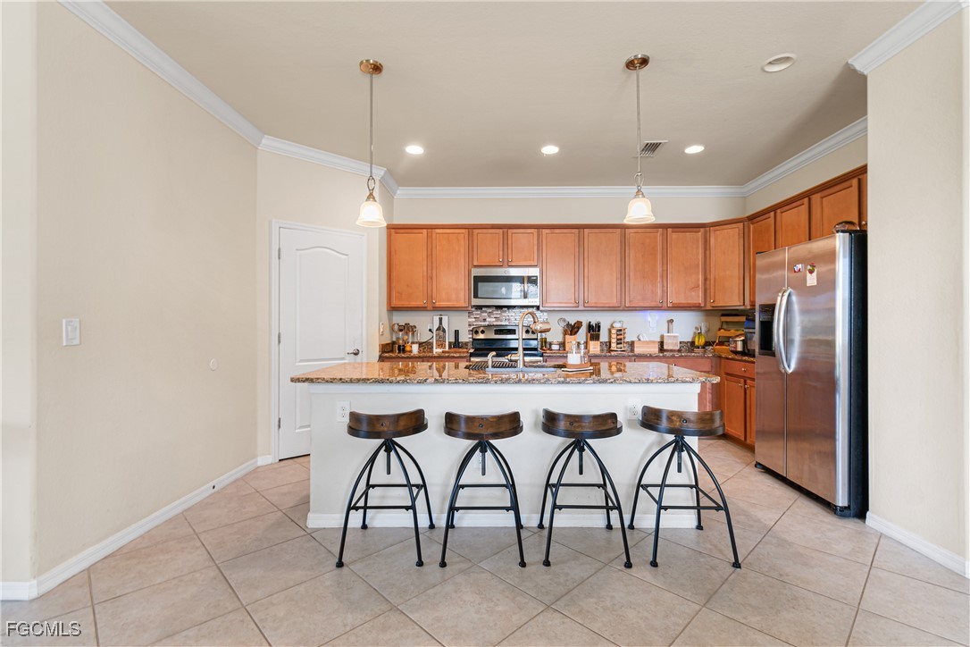 11656 Eros Road Lehigh Acres, FL 33971 - Photo 14 of 49 a kitchen with a sink a counter top space and appliances