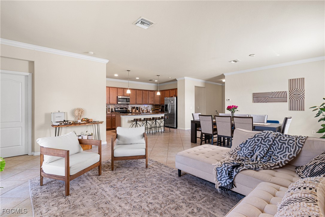 11656 Eros Road Lehigh Acres, FL 33971 - Photo 19 of 49 a living room with furniture and kitchen view