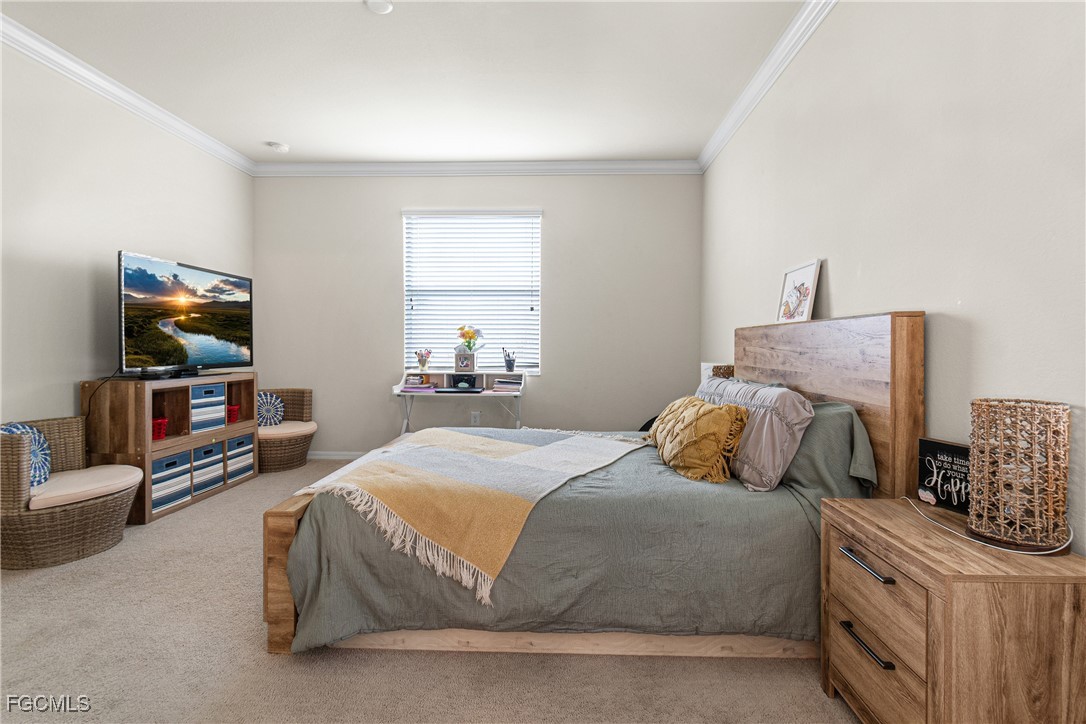 11656 Eros Road Lehigh Acres, FL 33971 - Photo 23 of 49 a bedroom with a bed and a flat screen tv