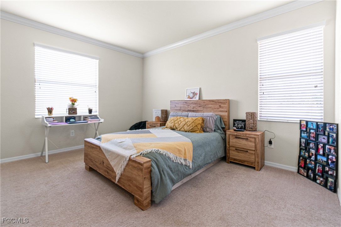 11656 Eros Road Lehigh Acres, FL 33971 - Photo 24 of 49 a bedroom with a bed and a closet