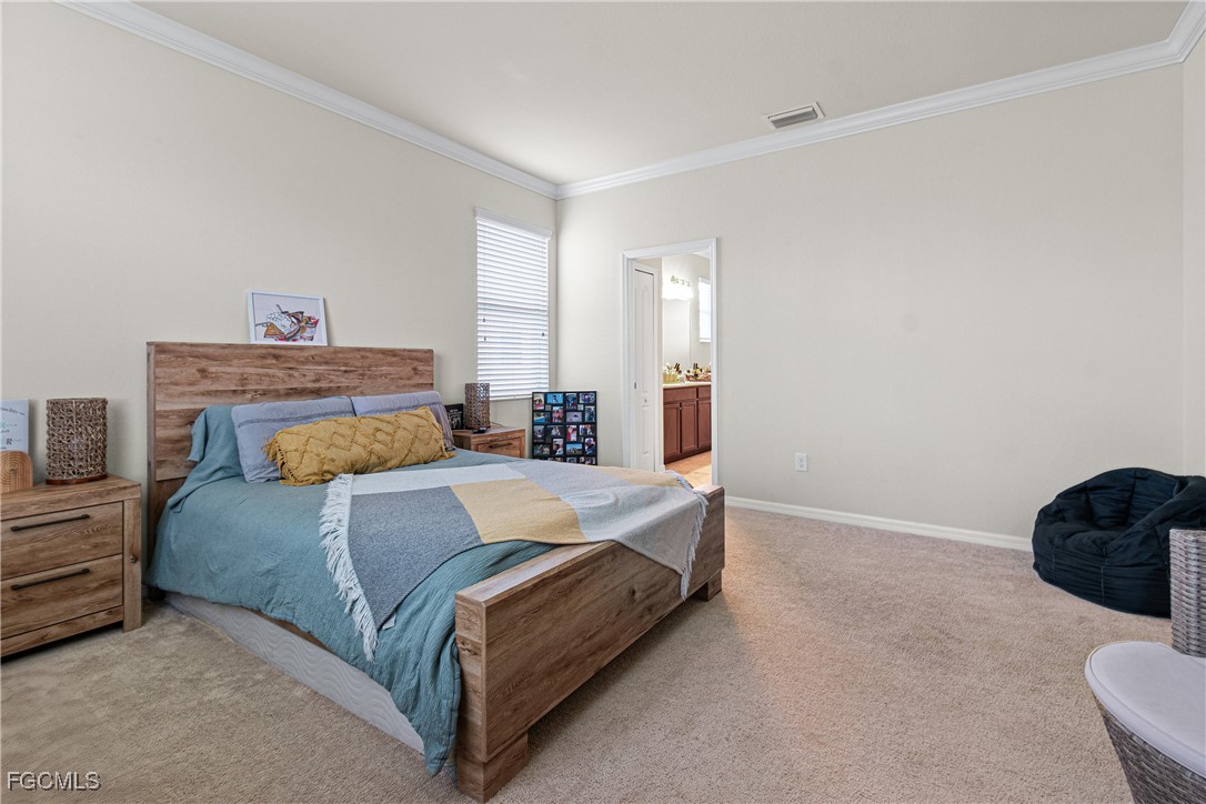 11656 Eros Road Lehigh Acres, FL 33971 - Photo 25 of 49 a bedroom with a bed and a lamp with window