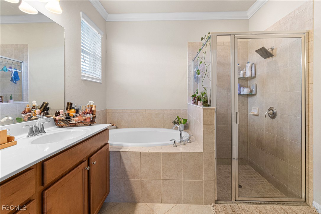 11656 Eros Road Lehigh Acres, FL 33971 - Photo 26 of 49 a bathroom with a bathtub and a sink