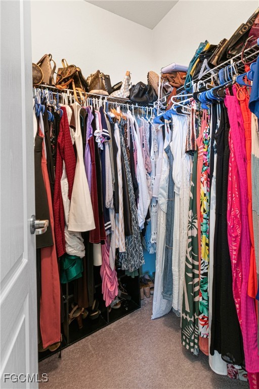 11656 Eros Road Lehigh Acres, FL 33971 - Photo 28 of 49 a view of walk in closet with clothes