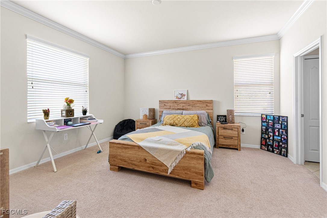 11656 Eros Road Lehigh Acres, FL 33971 - Photo 31 of 49 a bedroom with a bed and a window