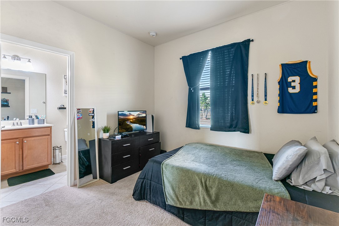 11656 Eros Road Lehigh Acres, FL 33971 - Photo 34 of 49 a bedroom with a bed and furniture