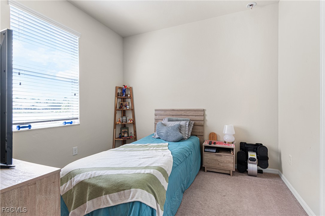 11656 Eros Road Lehigh Acres, FL 33971 - Photo 36 of 49 a bedroom with a bed and a window