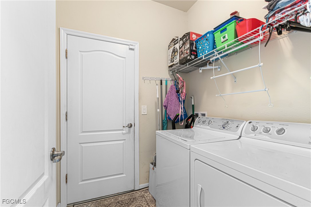 11656 Eros Road Lehigh Acres, FL 33971 - Photo 37 of 49 a utility room with dryer and washer