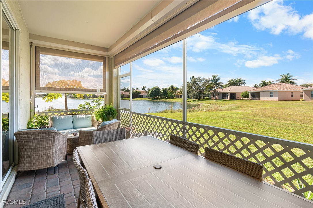11656 Eros Road Lehigh Acres, FL 33971 - Photo 39 of 49 a view of a balcony with lake view and wooden floor