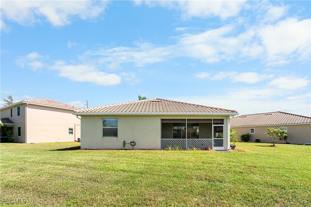 11656 Eros Road Lehigh Acres, FL 33971 - Photo 43 of 49 a front view of a house with a garden