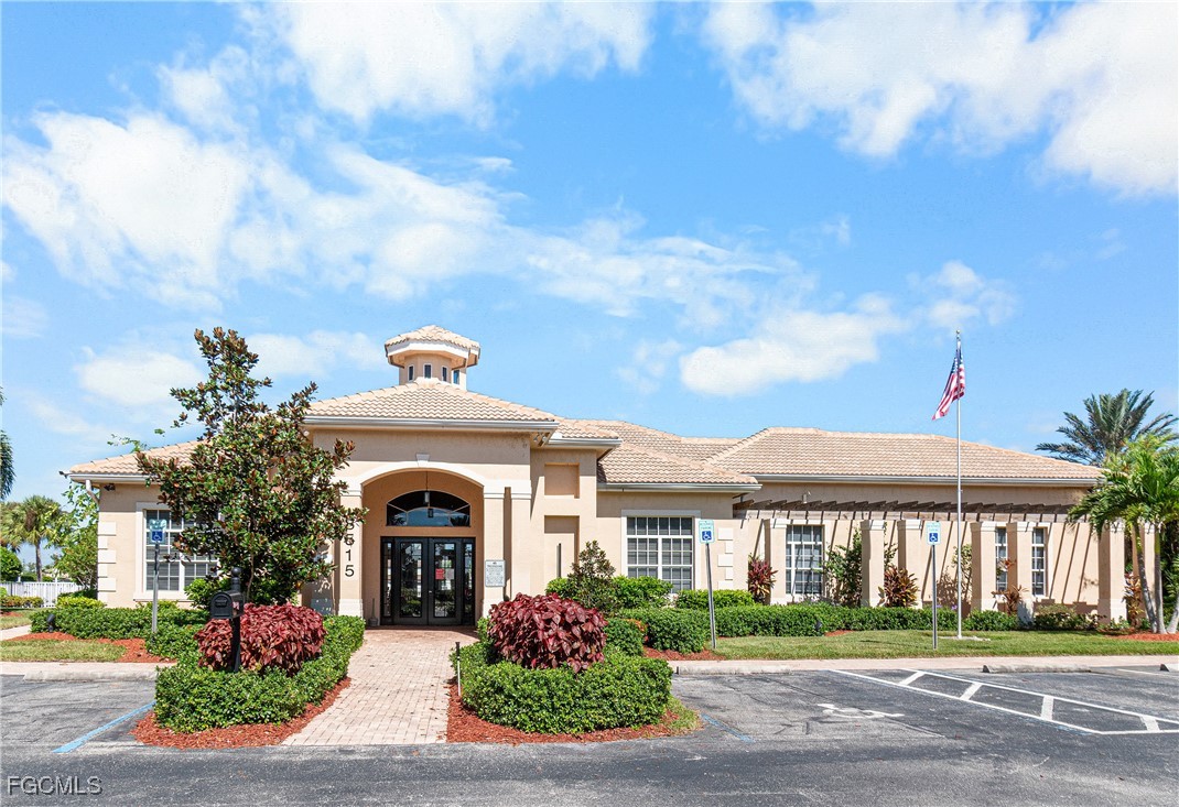 11656 Eros Road Lehigh Acres, FL 33971 - Photo 45 of 49 a front view of a building with garden