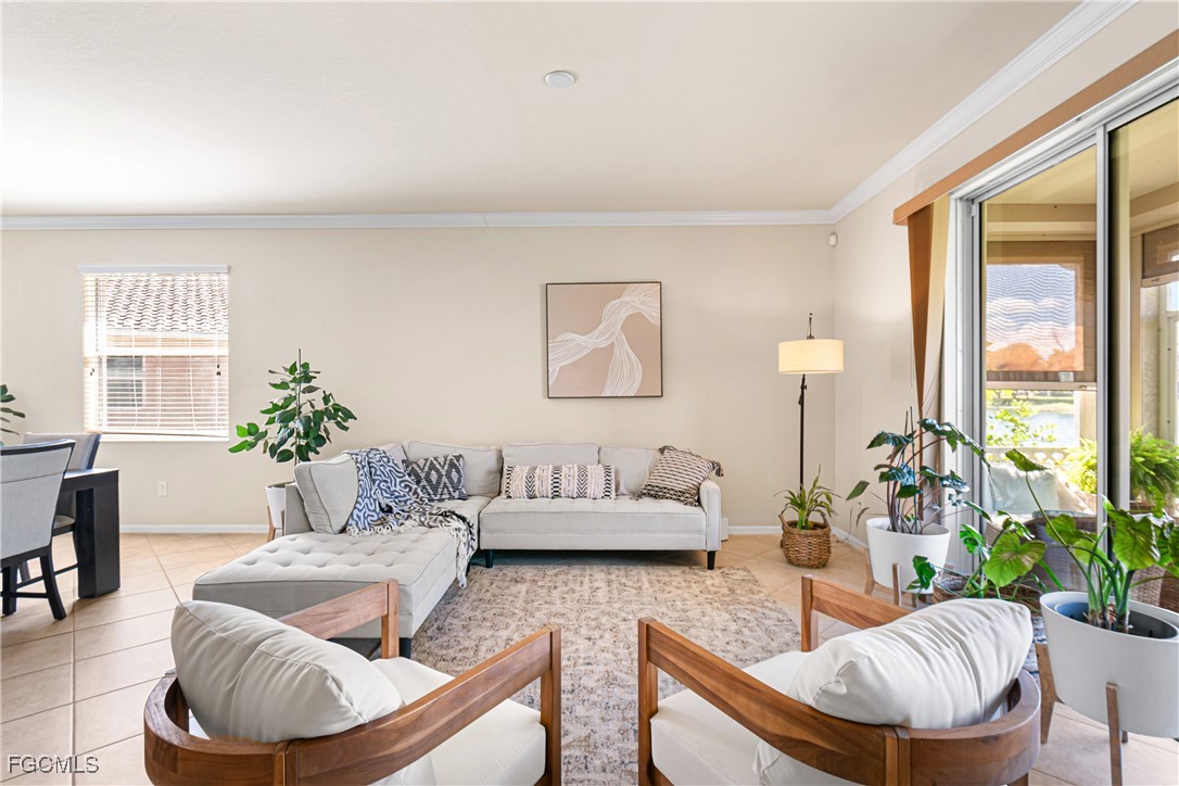 11656 Eros Road Lehigh Acres, FL 33971 - Photo 5 of 49 a living room with furniture and a large window