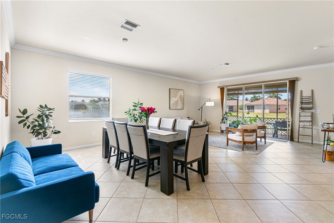 11656 Eros Road Lehigh Acres, FL 33971 - Photo 9 of 49 a view of a dining room with furniture and a potted plant