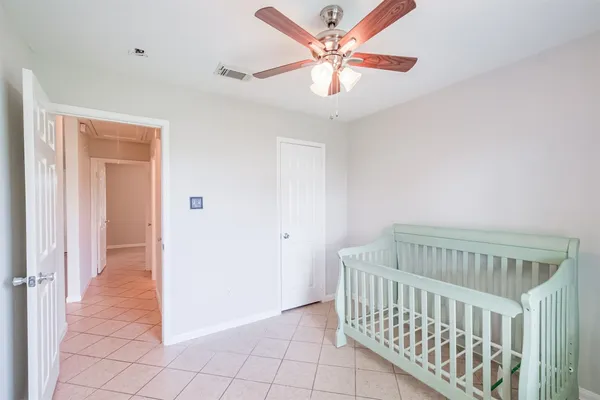 an empty room with window and ceiling fan
