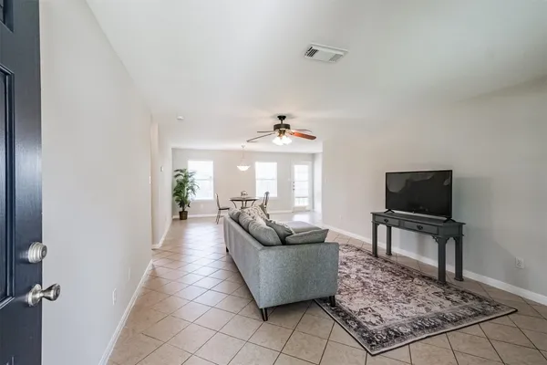 a living room with furniture and a rug