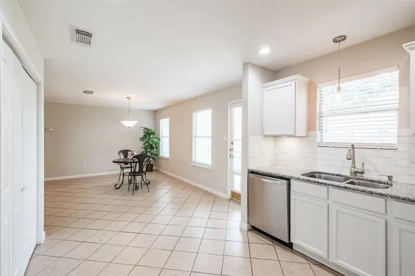 a kitchen with a sink a stove and a refrigerator