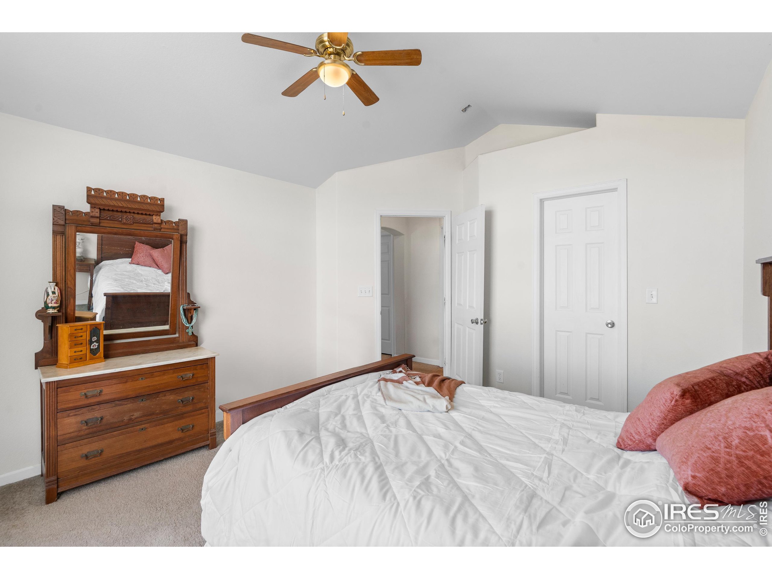 5151 29th Street, Unit 1311 Greeley, CO 80634 - Photo 12 of 16 a bedroom with a bed and wooden floor