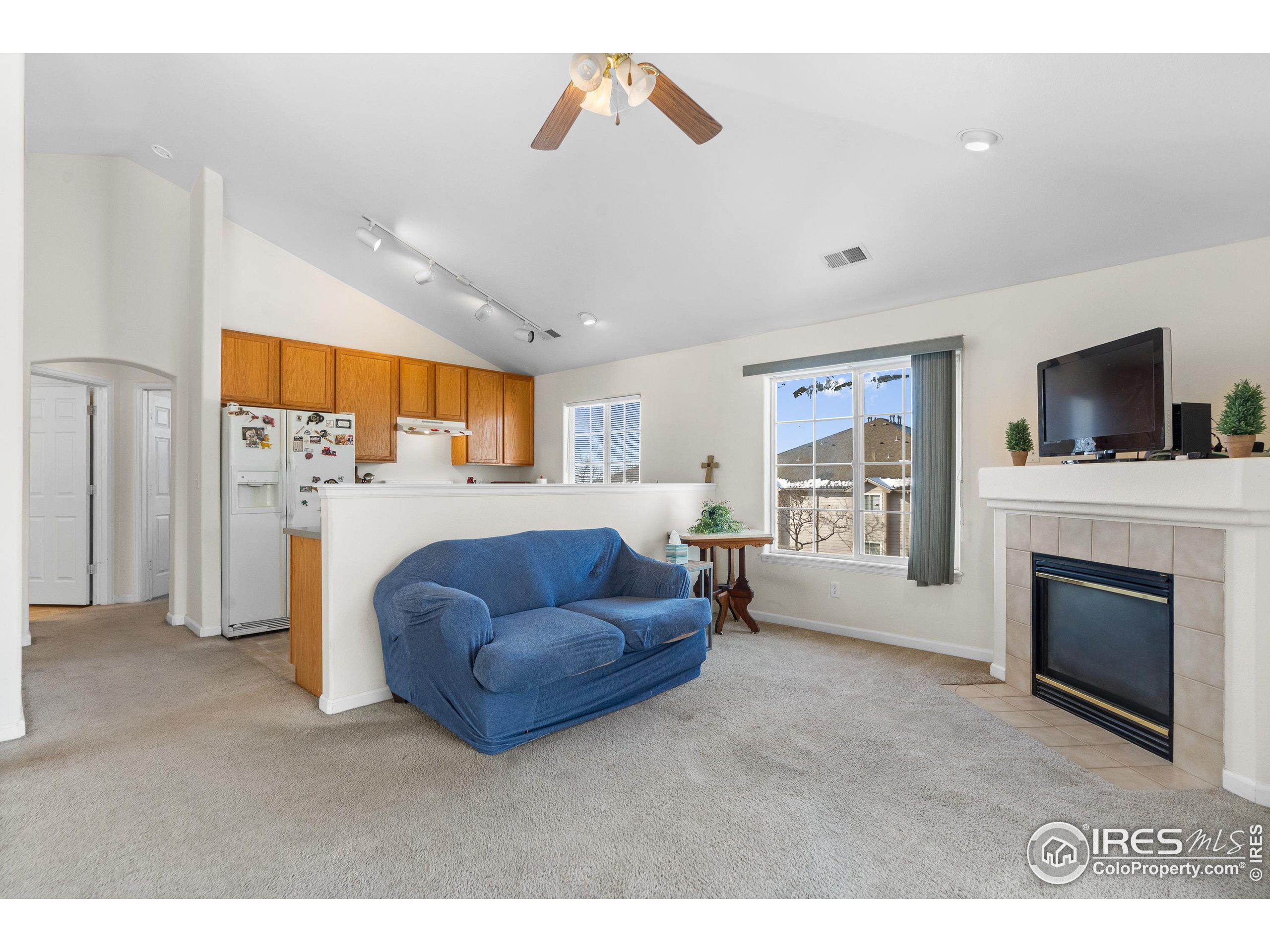 5151 29th Street, Unit 1311 Greeley, CO 80634 - Photo 6 of 16 a living room with furniture and a fireplace