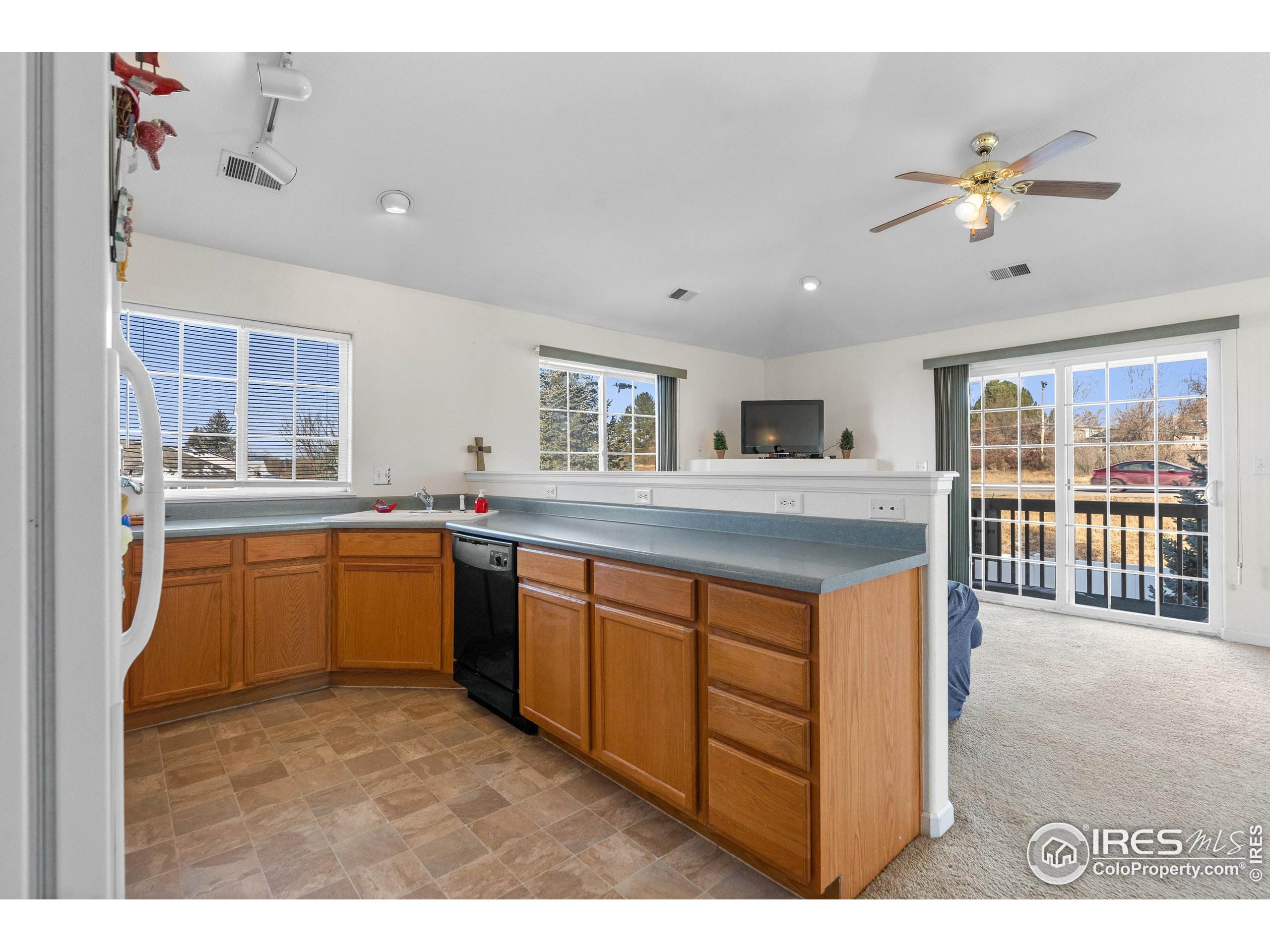5151 29th Street, Unit 1311 Greeley, CO 80634 - Photo 9 of 16 a kitchen with stainless steel appliances granite countertop a sink and cabinets