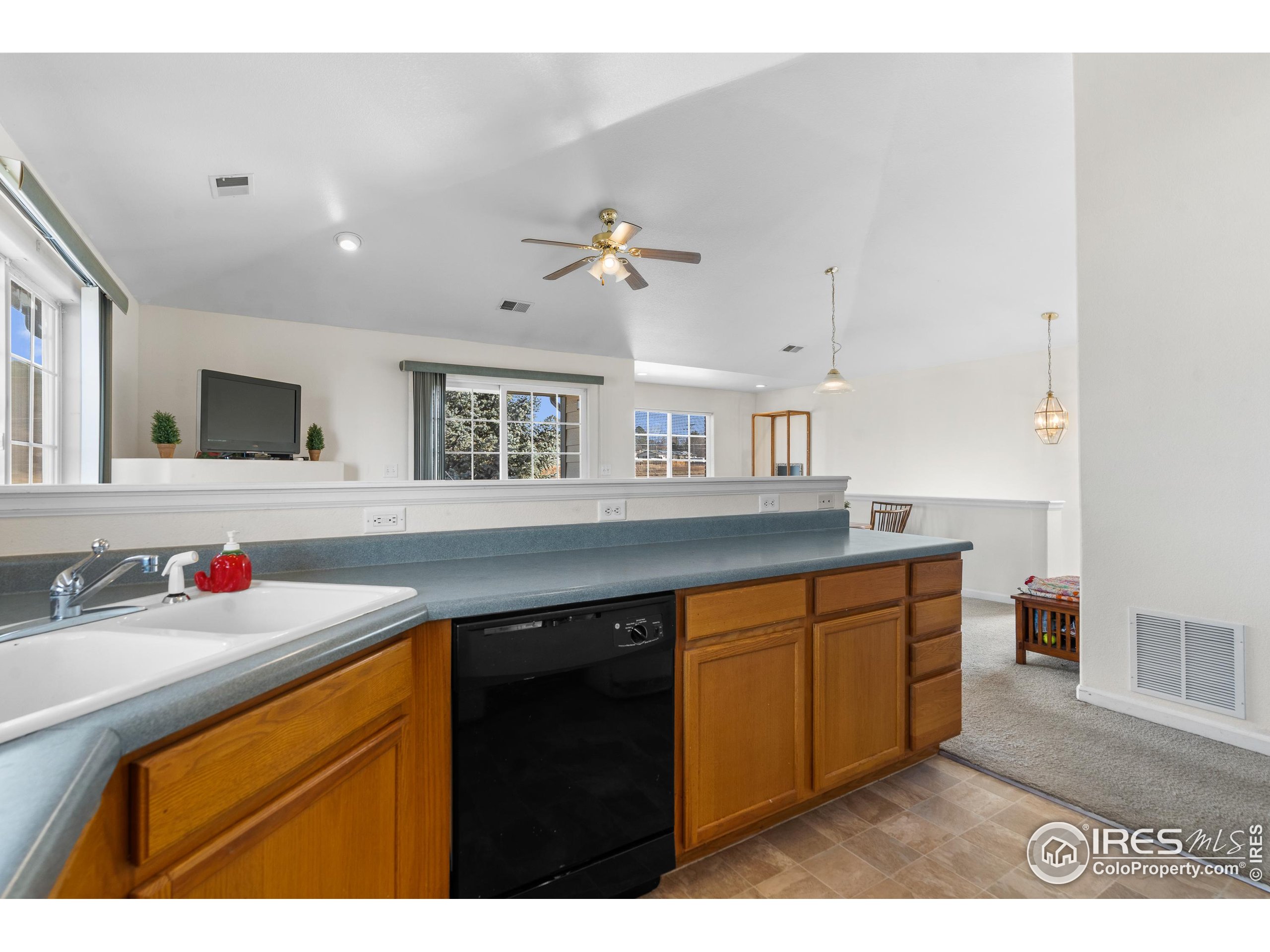 5151 29th Street, Unit 1311 Greeley, CO 80634 - Photo 10 of 16 a kitchen with stainless steel appliances a sink stove and cabinets