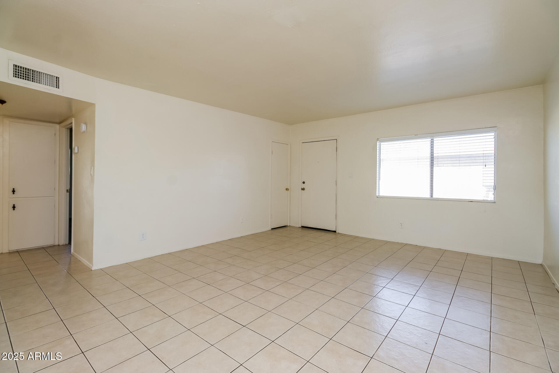1326 North Miller Road, Unit B Tempe, AZ 85288 - Photo 4 of 11 an empty room with windows