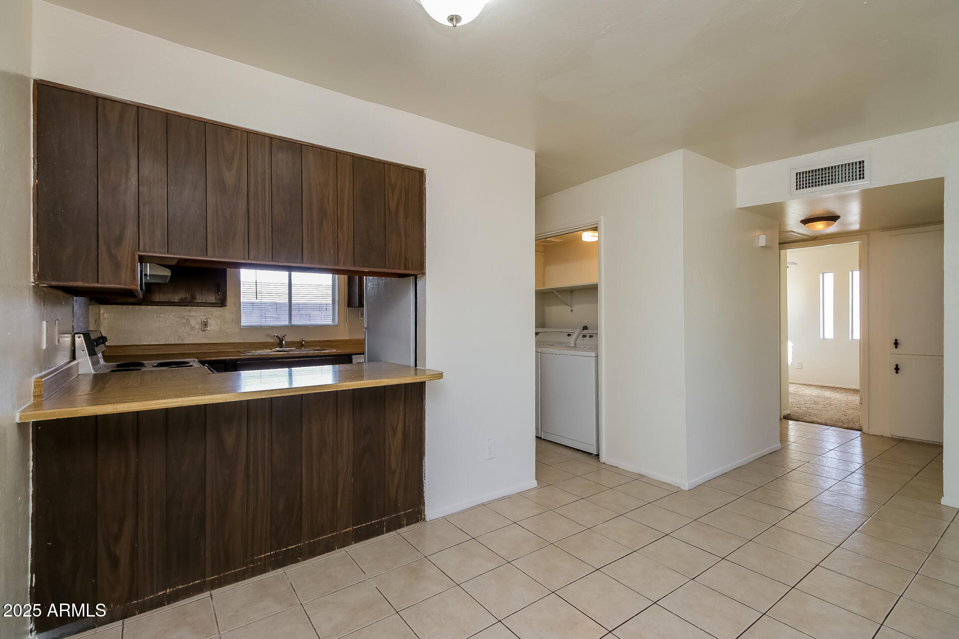1326 North Miller Road, Unit B Tempe, AZ 85288 - Photo 5 of 11 a kitchen with stainless steel appliances a sink stove and refrigerator