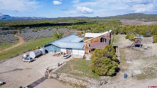 an aerial view of a house with a lake view