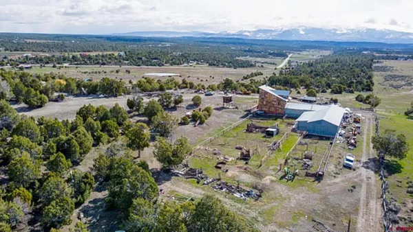 an aerial view of a house with a yard