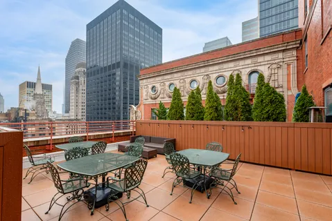 a swimming pool with outdoor seating and city view