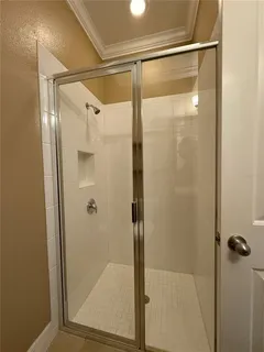 a view of walk in closet with clothes