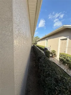 a view of a house with backyard and swimming pool
