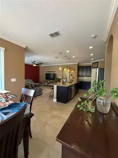 a living room with furniture a lamp and a flat screen tv