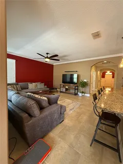 a kitchen with a dining table chairs and refrigerator