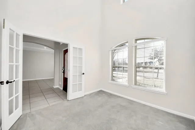 a view of a hallway with wooden floor and a living room