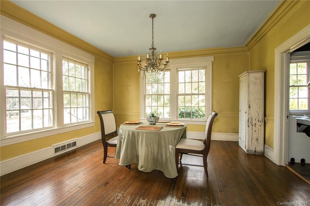 528 North Main Street Rutherfordton, NC 28139 - Photo 7 of 22 a dining room with wooden floor a chandelier a wooden table and chairs