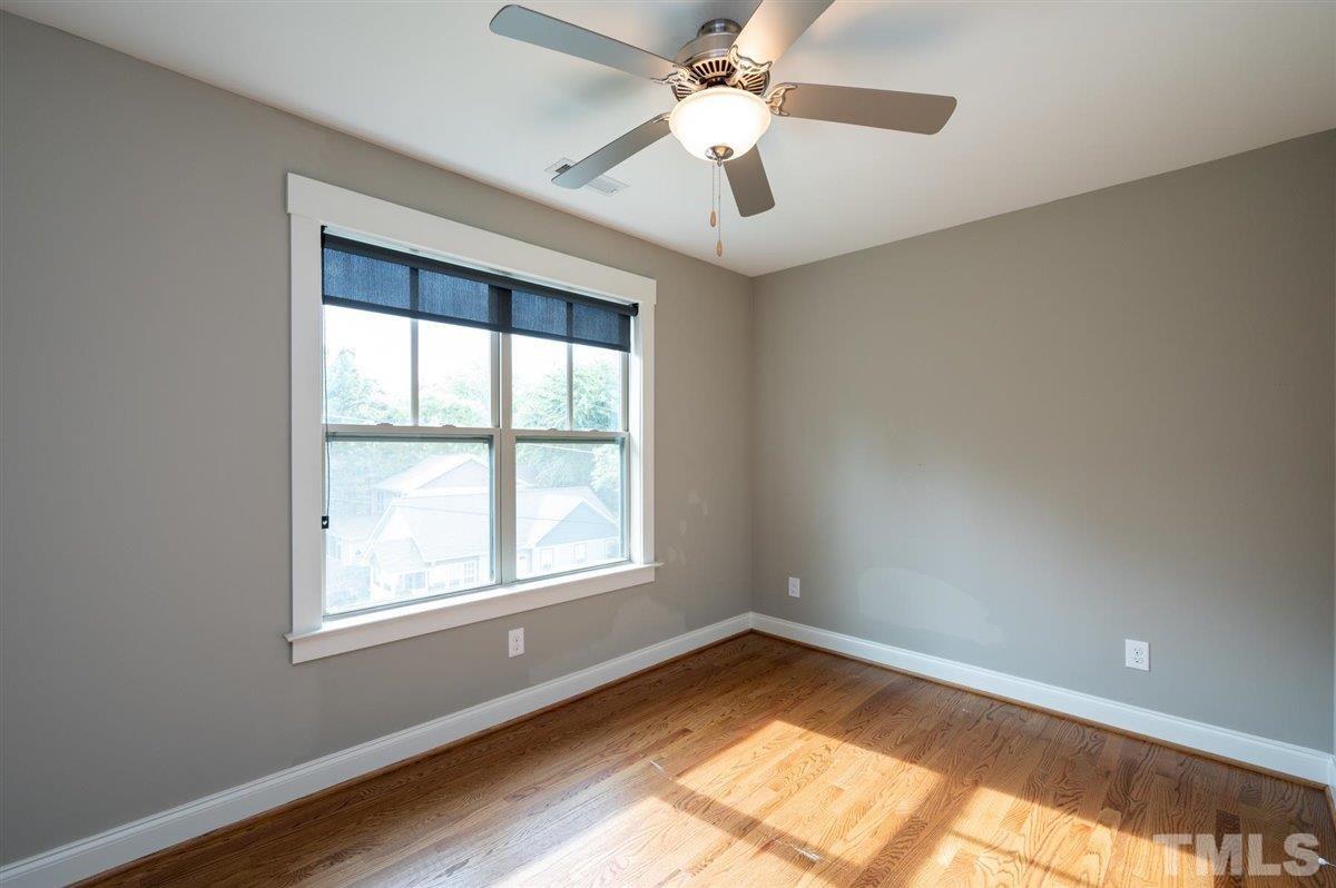 112 Cooke Street Raleigh, NC 27601 - Photo 22 of 26 an empty room with a window and wooden floor