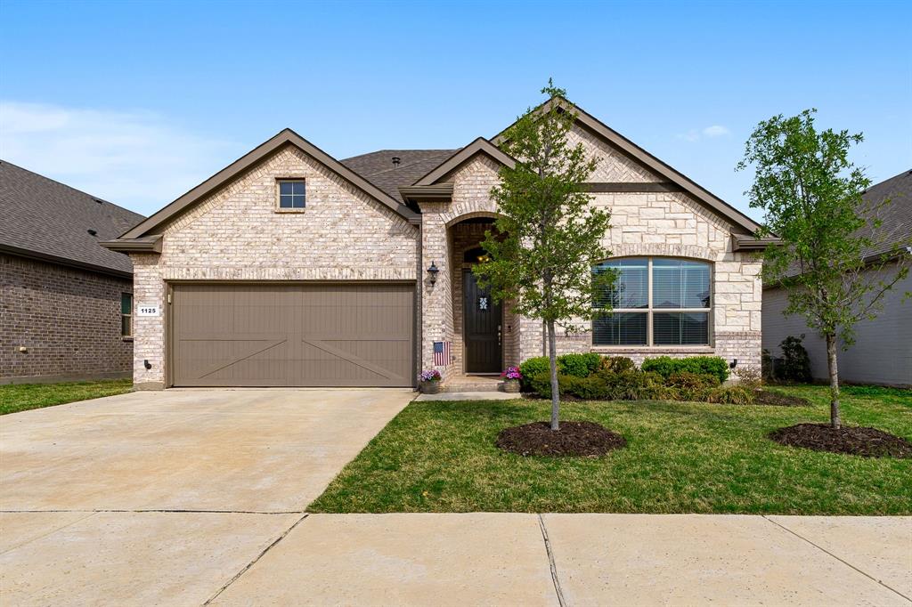 1125 Knightsbridge Road Argyle, TX 76226 - Photo 1 of 27 a front view of a house with a garden and plants