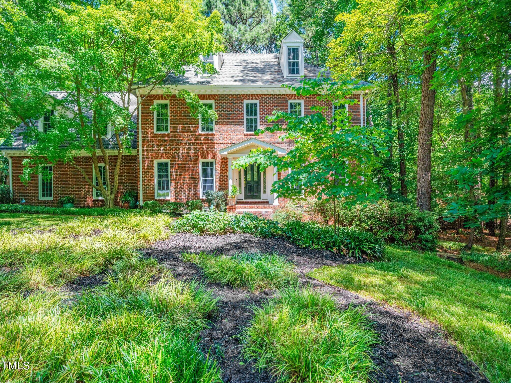a front view of house with yard and green space