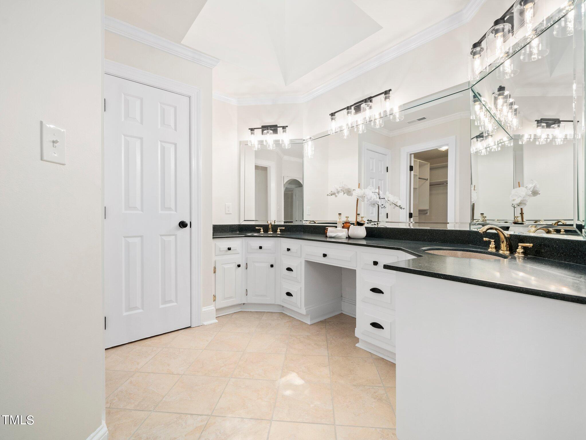2900 Kenwick Court Raleigh, NC 27613 - Photo 19 of 34 a large white bathroom with a sink and a large mirror
